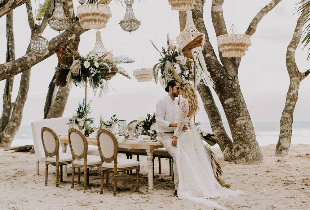 bride and groom at their boho chic reception setup