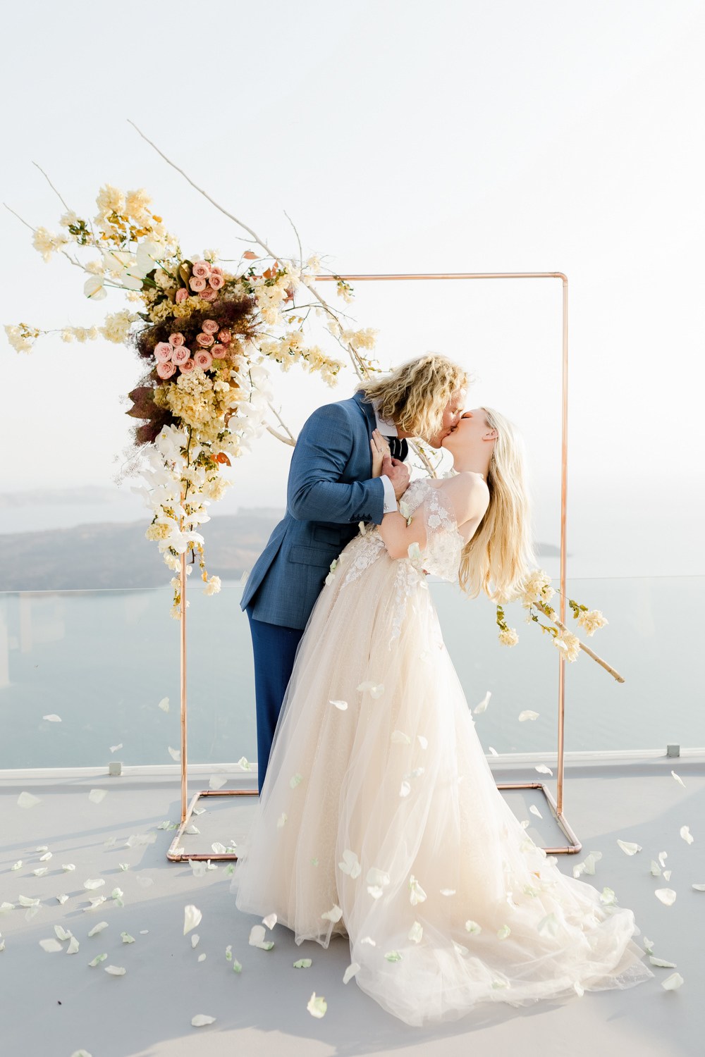 bride and groom kiss during the ceremony