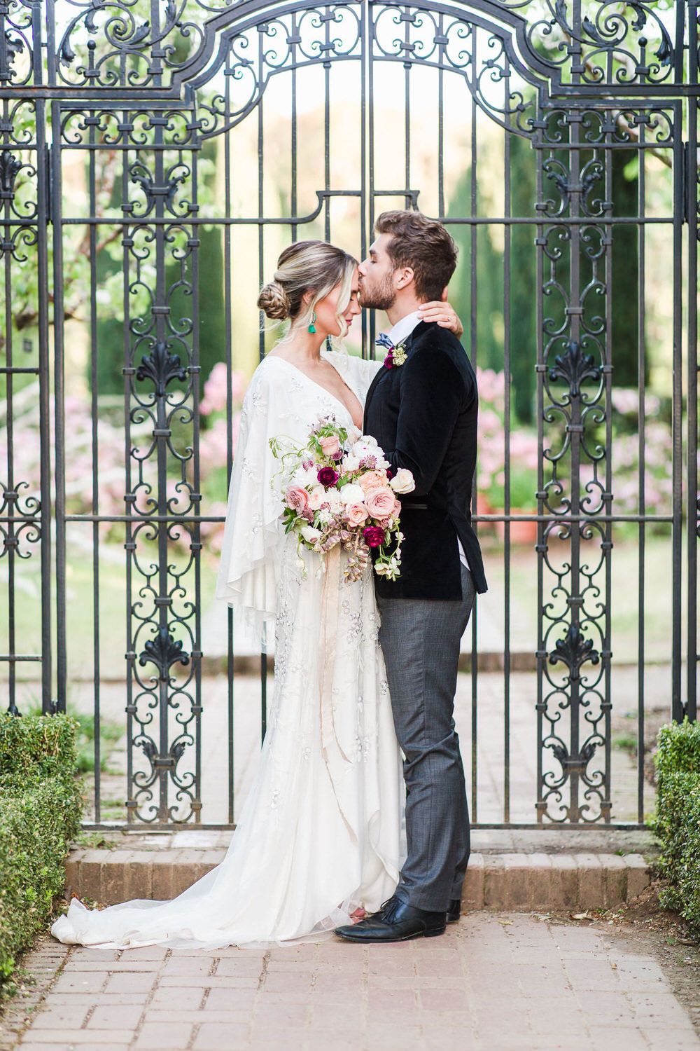 groom sweetly kisses the bride's forehead