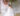 bride smiles as she twirls in her off-the-shoulder dress