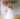 bride smiles as she twirls in her off-the-shoulder dress